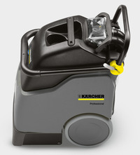 Kärcher professional carpet cleaner with grey body, black top, and large wheels, featuring a yellow control knob.