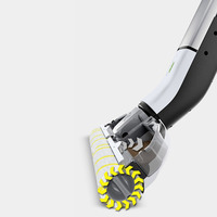 Kärcher floor cleaner with rotating brush, featuring yellow directional arrows on a white background.