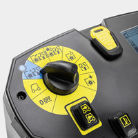 Control panel of a Kärcher cleaning machine with a black dial and yellow settings icons, including power and cleaning modes.