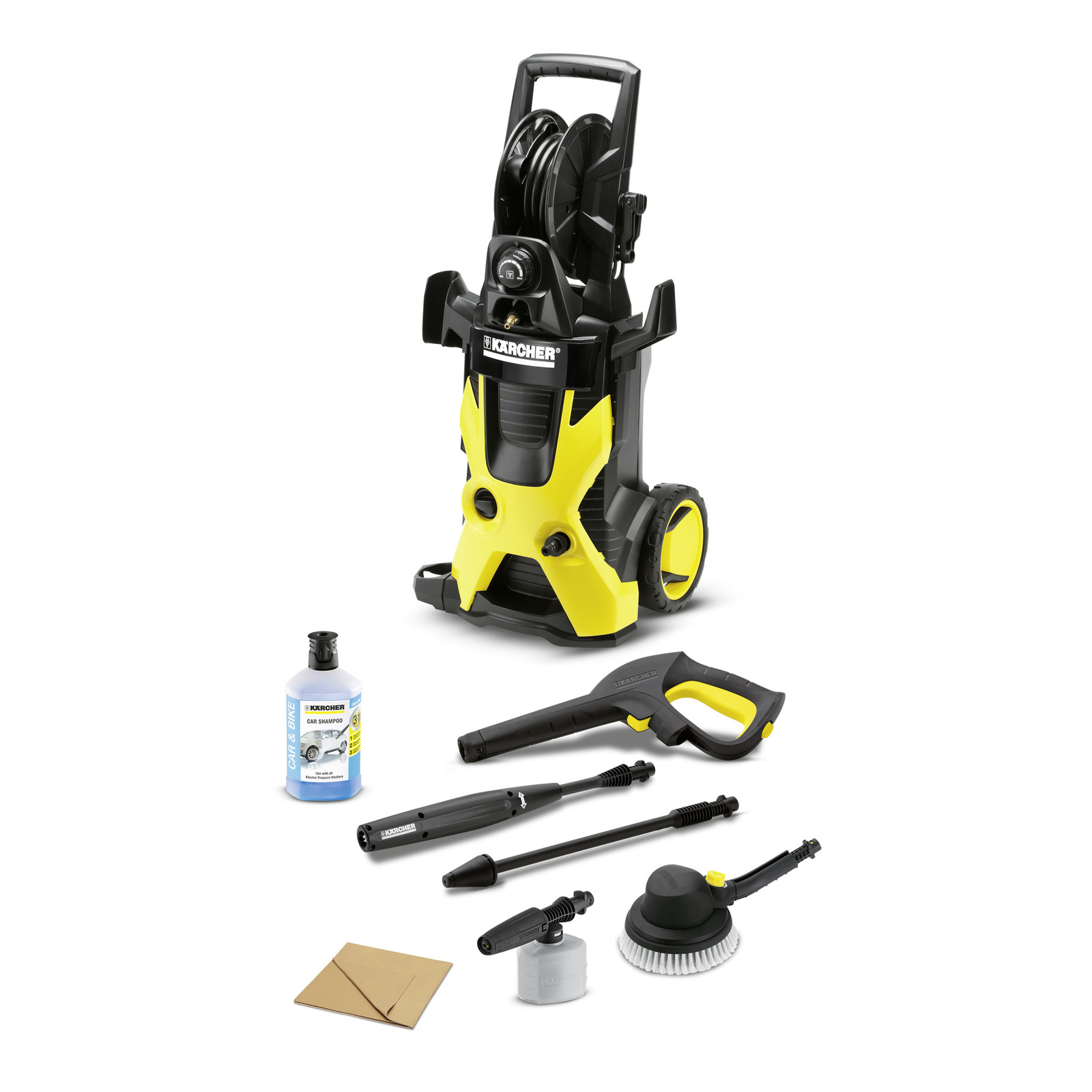 Kärcher high-pressure cleaner with accessories including a spray gun, detergent bottle, lance, brush, and nozzle on a white background.
