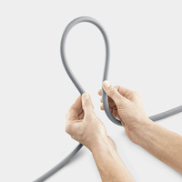 Hands holding a grey hose, forming a loop against a plain white background.