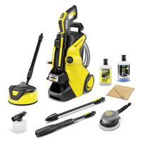 Kärcher high-pressure cleaner with accessories, including detergent bottles, a brush, and various nozzles, set against a white background.