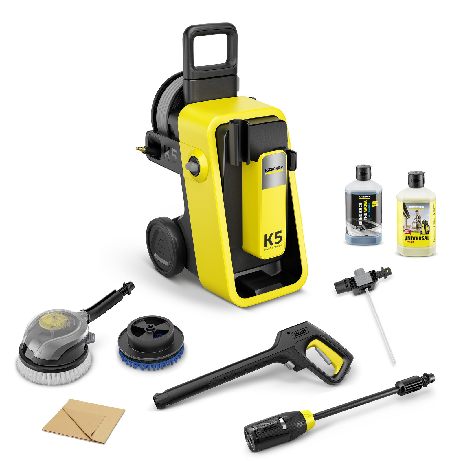 Kärcher K5 high-pressure cleaner with accessories, including two brushes, spray gun, detergent bottles, and hose attachments, on a white background.