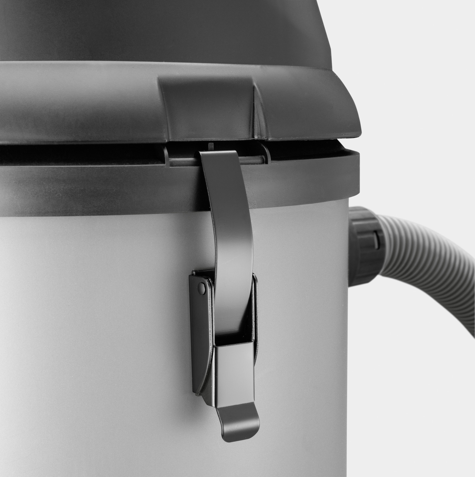 Close-up of a Kärcher wet and dry vacuum cleaner showing the latch and hose connection on a grey and black body.