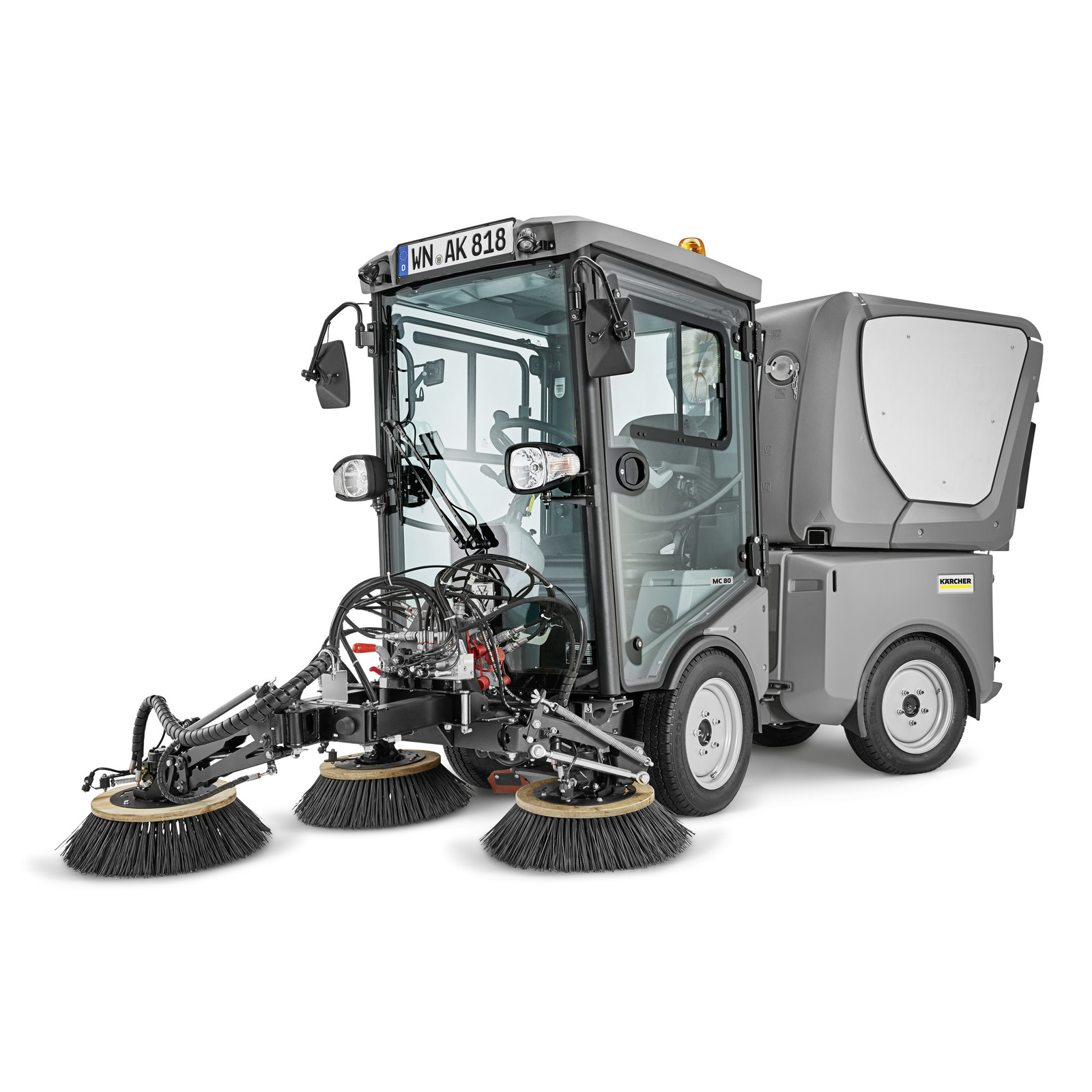 Kärcher street sweeper with three rotating brushes, enclosed cab, and grey body, designed for outdoor cleaning tasks.