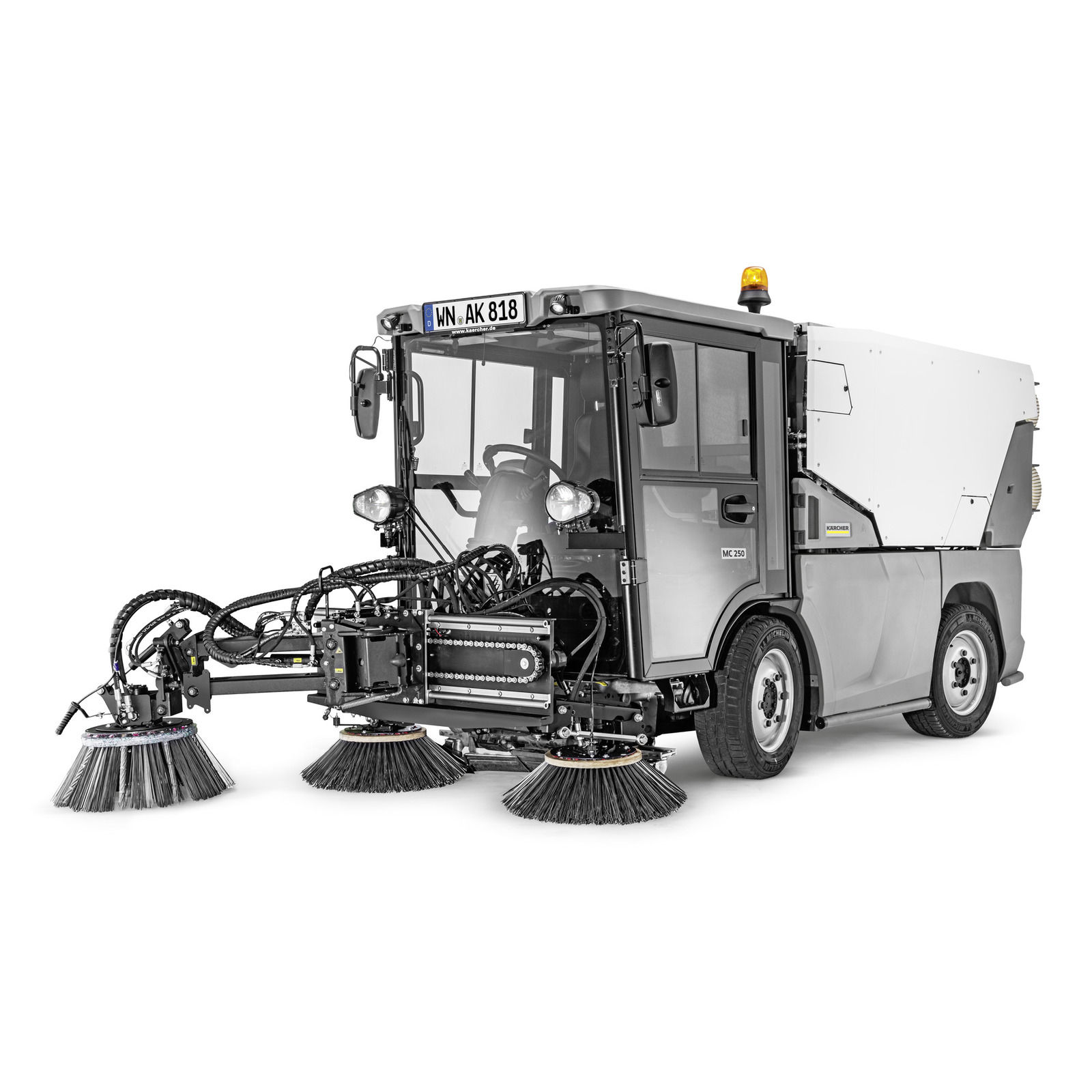 Kärcher street sweeper with rotating brushes and enclosed cab, featuring a mounted light on top.