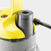 Close-up of a Kärcher submersible pump with a yellow handle, black cable, and visible measurement markings on the grey body.