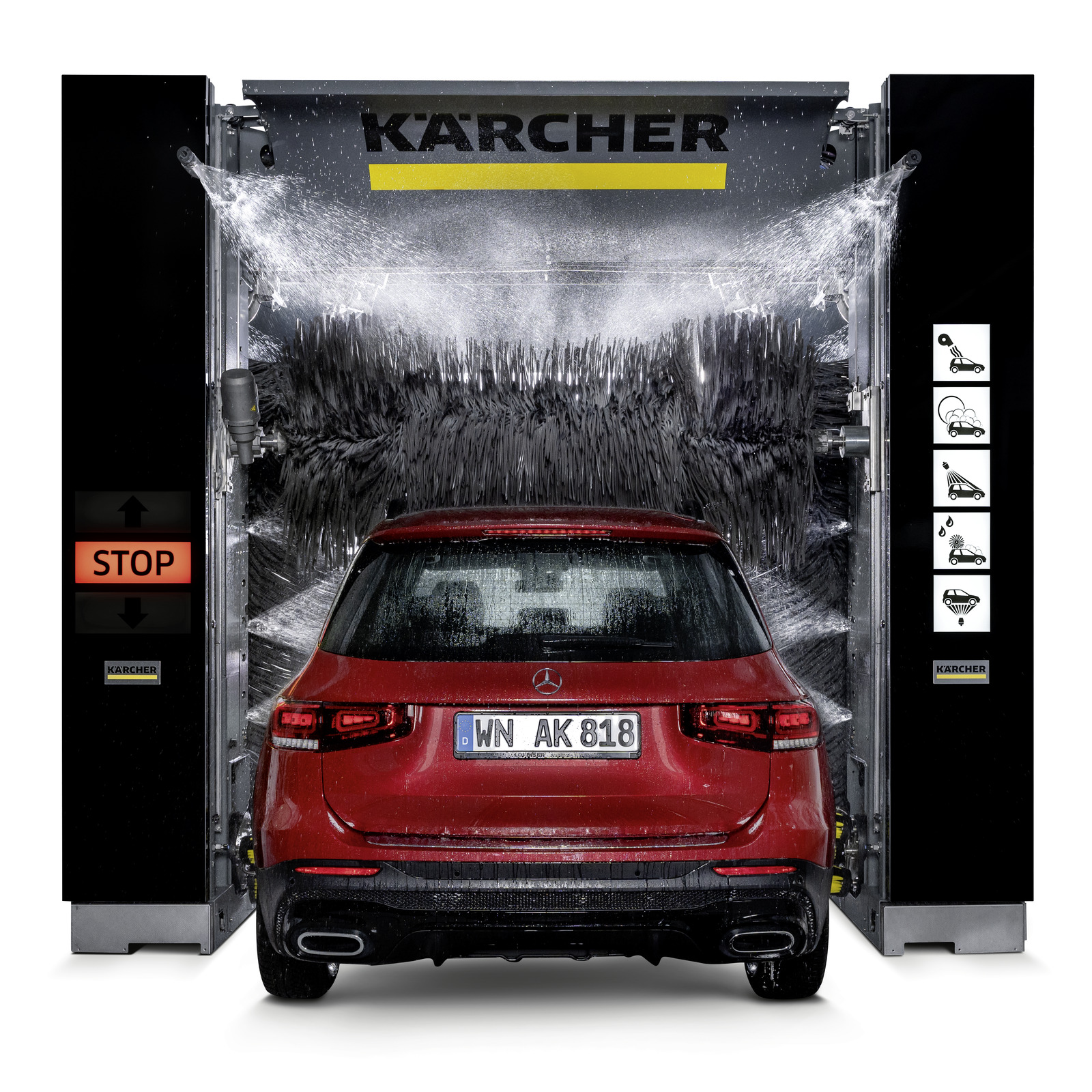 Red Mercedes-Benz SUV in a Kärcher car wash, surrounded by water and rotating brushes, with visible stop button and control icons.