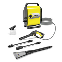 Kärcher high-pressure cleaner set with yellow unit, hose, spray gun, foam nozzle, and various attachments on white background.