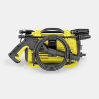Yellow Kärcher high-pressure cleaner with black hose and handle, compact design, viewed from the front against a white background.