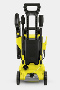 Front view of a Kärcher high-pressure cleaner with black and yellow design, featuring wheels and attached spray nozzles.