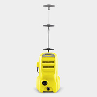 Yellow Kärcher high-pressure cleaner with telescopic handle, standing upright on a plain grey background.