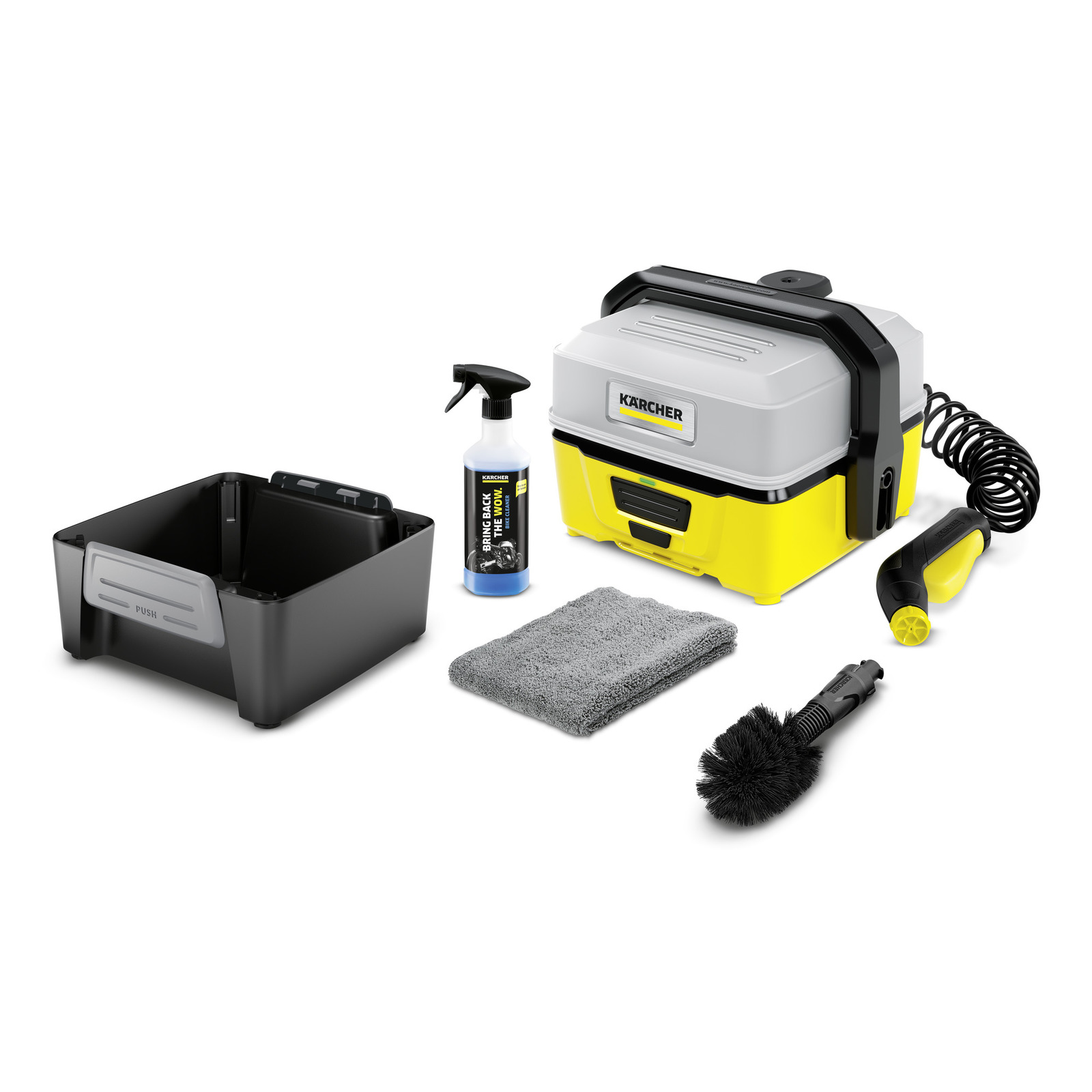 Kärcher portable cleaner with accessories: spray bottle, grey cloth, brush, black container, and yellow nozzle.