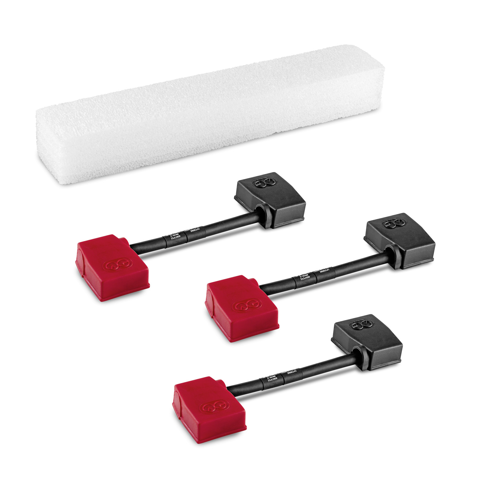 Three Kärcher floor spacer tools with red and black ends, placed beside a white foam block.