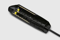 Black Kärcher surface cleaner attachment with yellow nozzles and brass rods on a grey background.