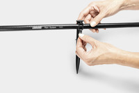 Hands adjusting a Kärcher Rain System hose with a connector on a white background.