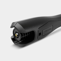 Close-up of a Kärcher high-pressure cleaner nozzle with textured grip and visible branding on a light grey background.