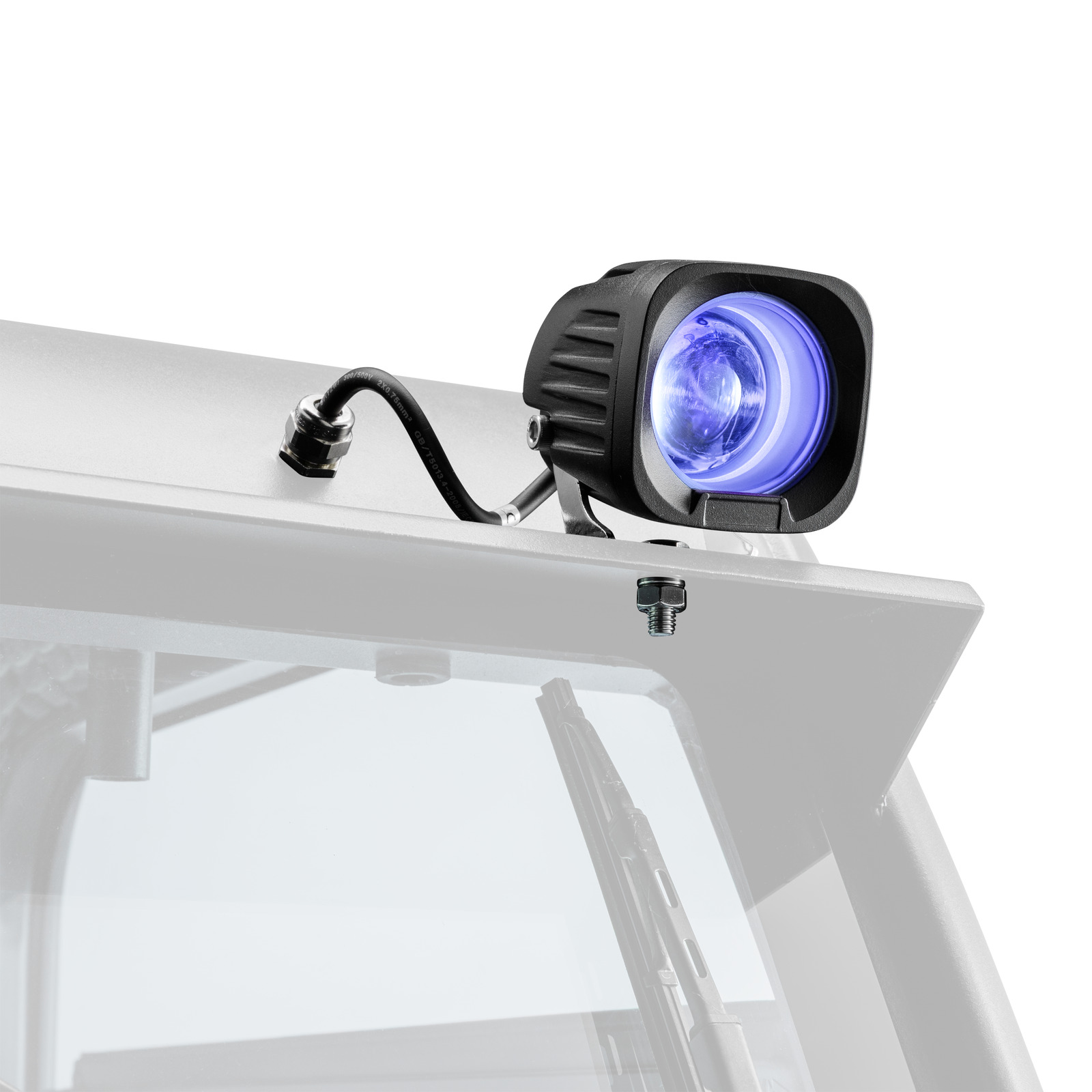A black, square auxiliary light with a blue glow, mounted on the white roof of a vehicle, with a windscreen and wiper blades visible below. A black, square auxiliary light with a blue glow, mounted on the white roof of a vehicle, with a windscreen and wiper blades visible below.