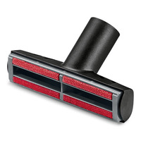 Kärcher upholstery nozzle with black plastic body and red fabric strips, angled view.
