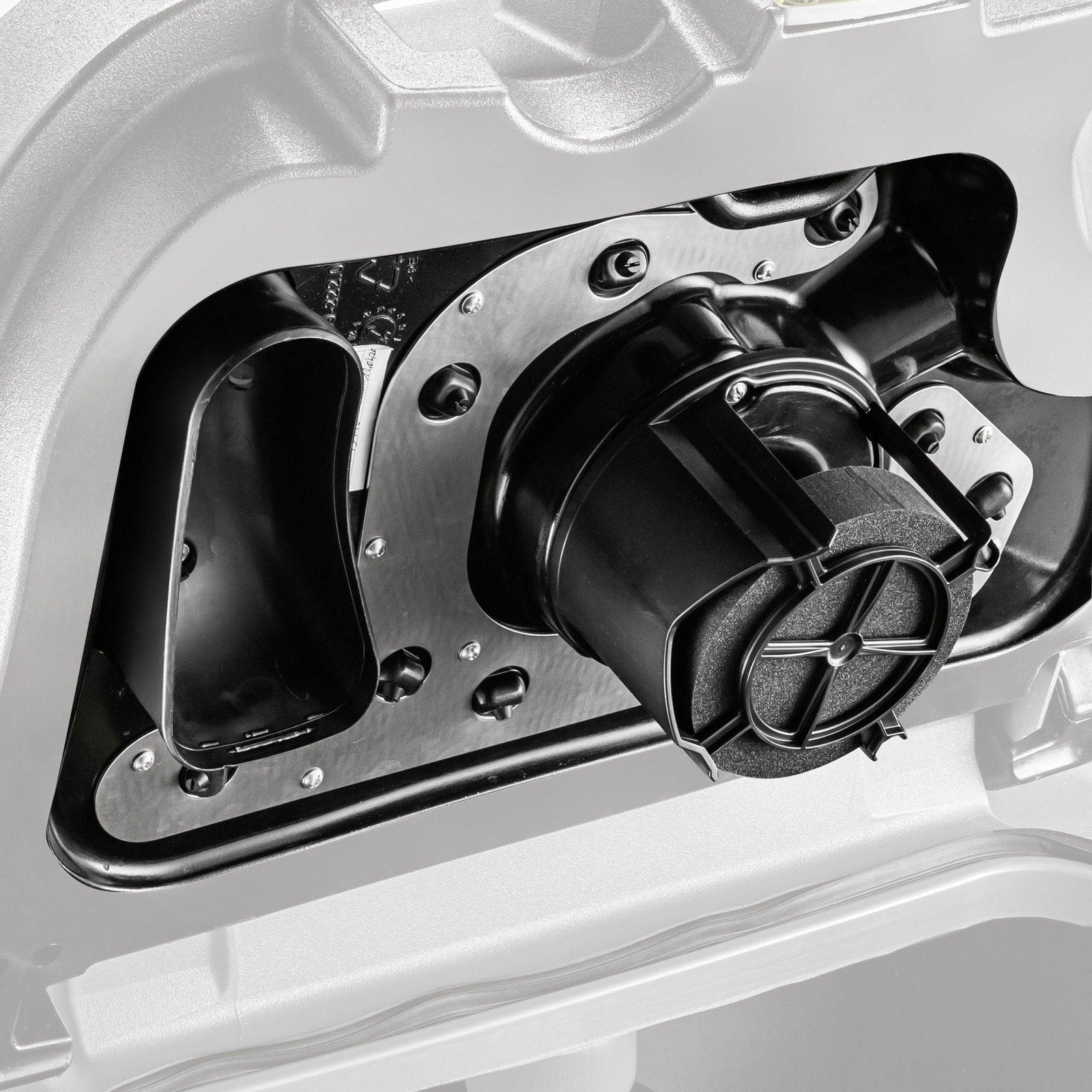 Close-up of a Kärcher device component featuring a black circular element with a textured surface, surrounded by metallic and plastic parts. Close-up of a Kärcher device component featuring a black circular element with a textured surface, surrounded by metallic and plastic parts.
