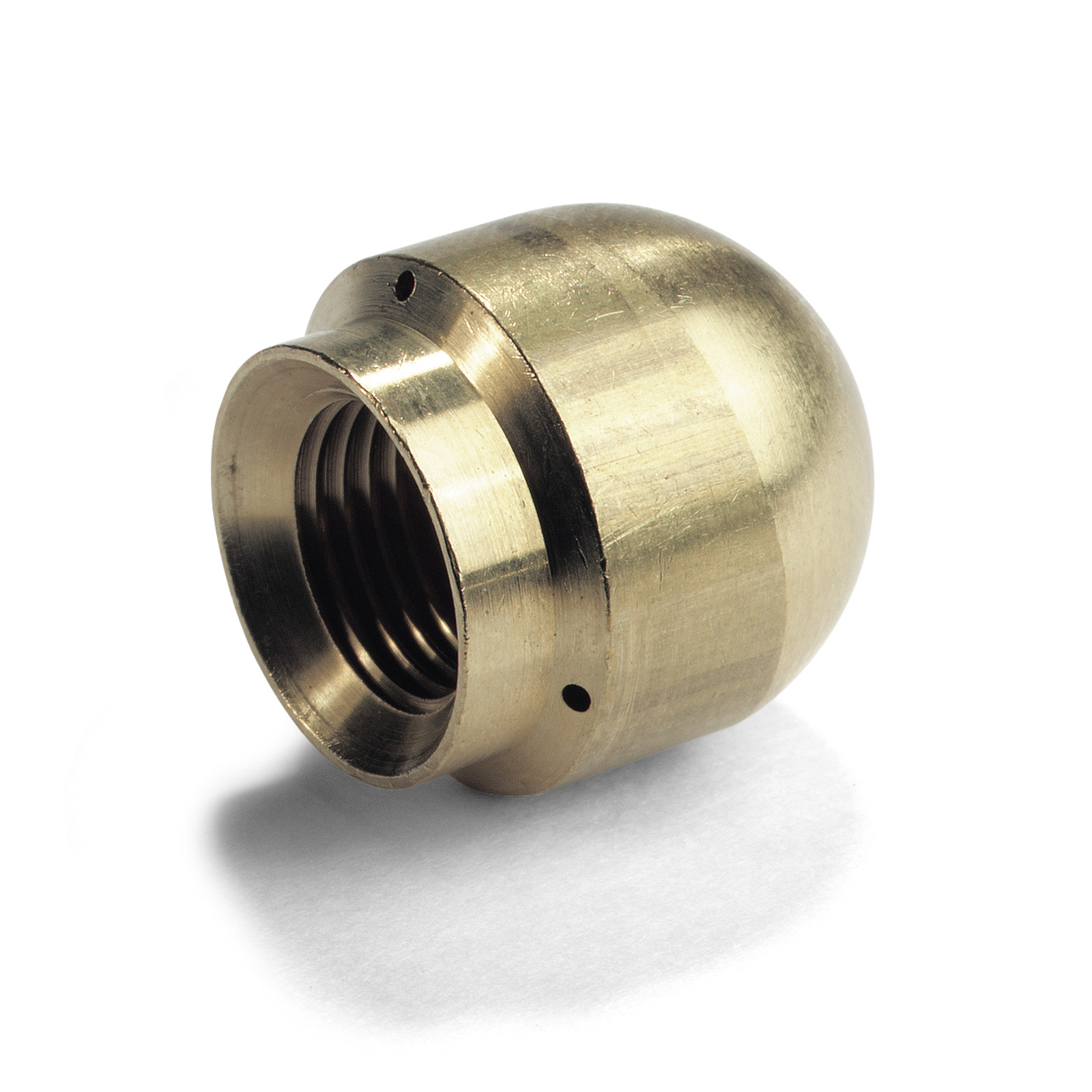 Brass nozzle with threaded interior, rounded top, and small side holes, resting on a white surface.