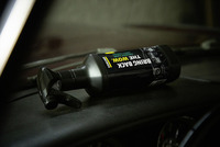 Kärcher cockpit care spray bottle on a car dashboard, with a black label featuring the text "Bring Back The Wow."