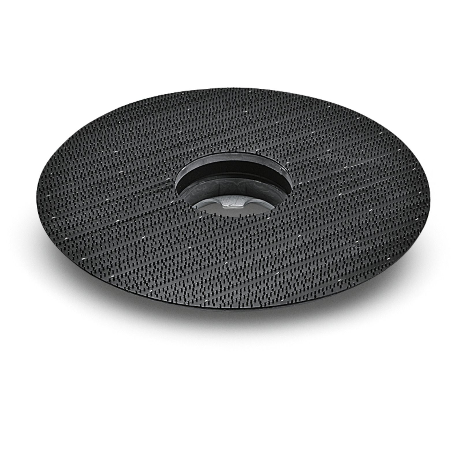 Black circular grinding disc with textured surface and central hole, viewed from an angle.