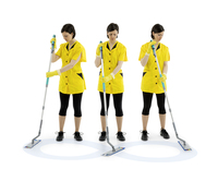 Three individuals in yellow uniforms and gloves using mops on a white surface, standing in a line.