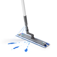 Kärcher spray mop with a grey handle, releasing blue liquid onto a white surface.