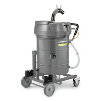 Kärcher industrial vacuum cleaner with grey cylindrical body on a wheeled frame, featuring a black hose attachment.